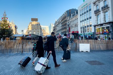 Tourists walking with their suitcases on the street in Brussels, Belgium