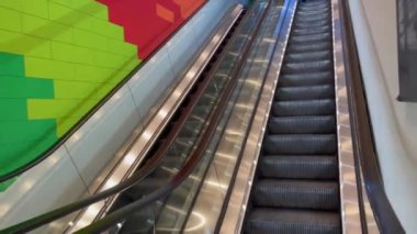 Taking the escalator up inside a shopping center in Brussels, Belgium