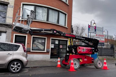 Telescopic boom lift parked on the roadside in Brussels, Belgium