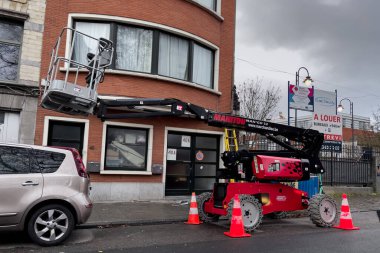 Telescopic boom lift parked on the roadside in Brussels, Belgium