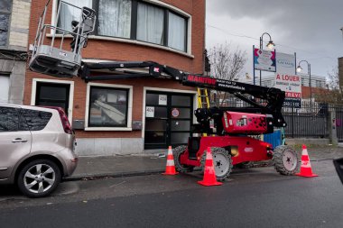 Telescopic boom lift parked on the roadside in Brussels, Belgium