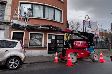 Telescopic boom lift parked on the roadside in Brussels, Belgium