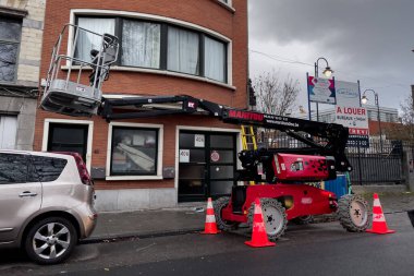 Telescopic boom lift parked on the roadside in Brussels, Belgium