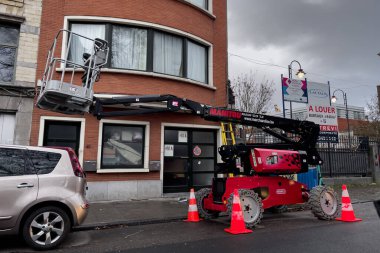 Telescopic boom lift parked on the roadside in Brussels, Belgium