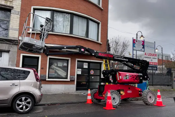 Telescopic boom lift parked on the roadside in Brussels, Belgium