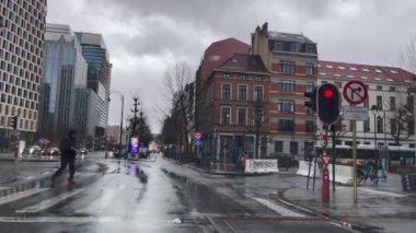 Red traffic light turned on during a rainy day in Brussels, Belgium
