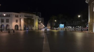 Cars driving on the road at night nearby The Bank Al Maghrib (Moroccan Central Bank) on Avenue Mohammed V in Rabat, Morocco