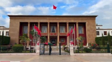 People walking by the Moroccan Parliament building in Rabat, Morocco
