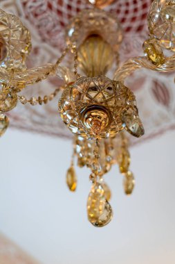 Crystal chandelier hanging on a white ceiling