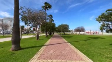 POV walking on the walkway in a public garden in Tangier, Morocco