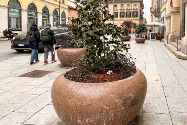 People walking in the city center of Novara, Italy