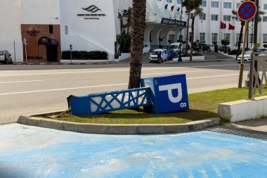 Underground parking sign fallen on the street in Tanger, Morocco