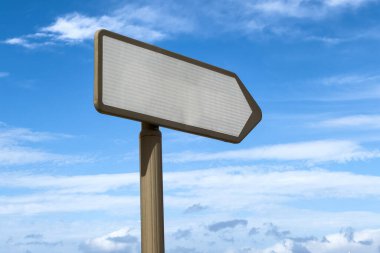 Blank right directional signpost with blue sky in the background clipart