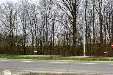 Car window view passing on the highway through a countryside in Belgium