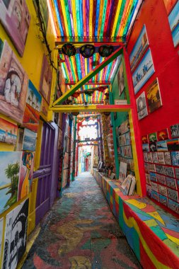 The popular colorful street in the old town of Fes with paintings hanging on the walls