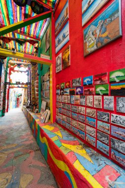 The popular colorful street in the old town of Fes with paintings hanging on the walls