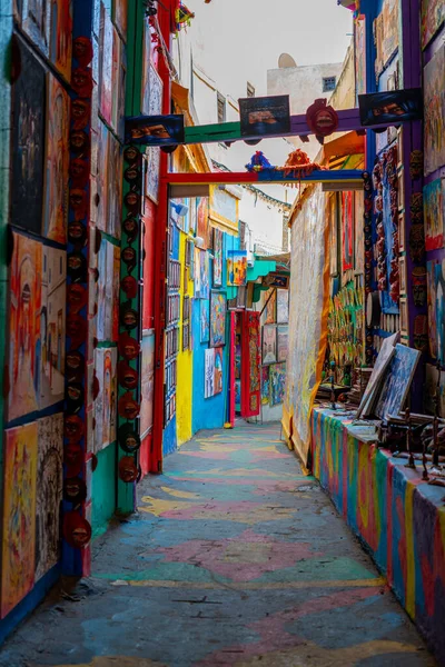 stock image The popular colorful street in the old town of Fes with paintings hanging on the walls