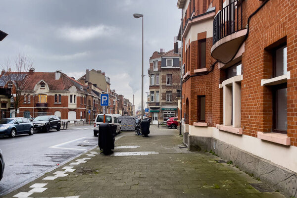 Cars parked on the roadside of an empty street in Brussels, Belgium