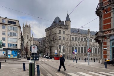 People walking on the street nearby Saint Bavo's Cathedral church in Ghent, Belgium clipart