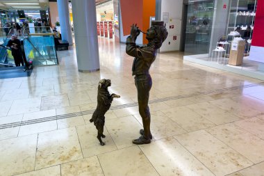 Bratislava, Slovakya 'daki Eurovea alışveriş merkezinde bir köpek ve bir müzisyenin bronz heykelleri
