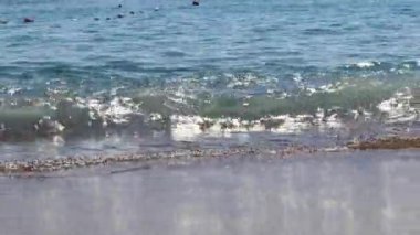 Sea, waves splashing on the shore with sand, white foam. Close-up. The concept of vacation, tourism, travel, coast, nature, environment, tour, meditation, 4k footage,resort, summer,countries, swimming