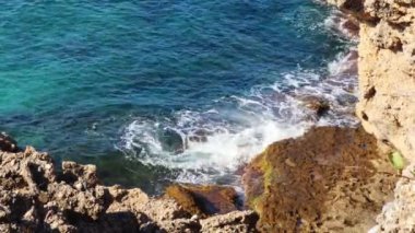 Sea. The wave beats against the rocks. Blue water, white foam. The concept of vacation, tourism, travel, coast, nature, environment, tour, meditation, 4k footage,resort, summer,countries, swimming.