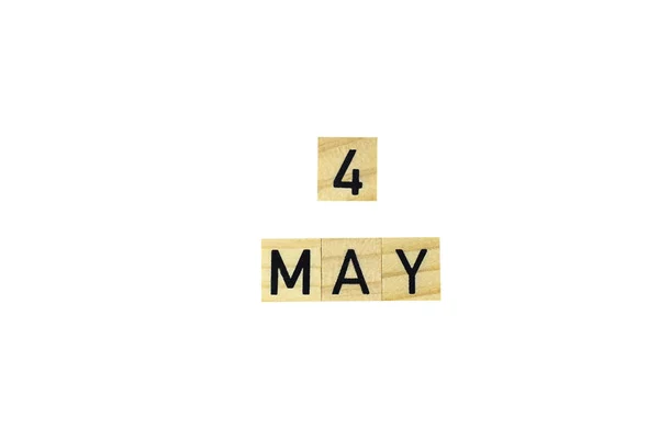 The word 4 may in wooden letters on a white background. Concept text, congratulation, spring, holiday, discounts, promotions, design, eco, copy space, poster,mock up,month,calendar,business,date.