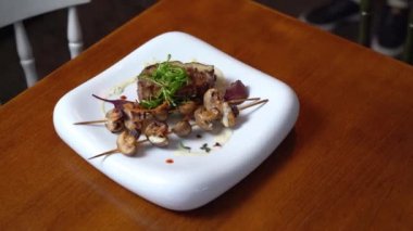 Steak in a restaurant on a white plate