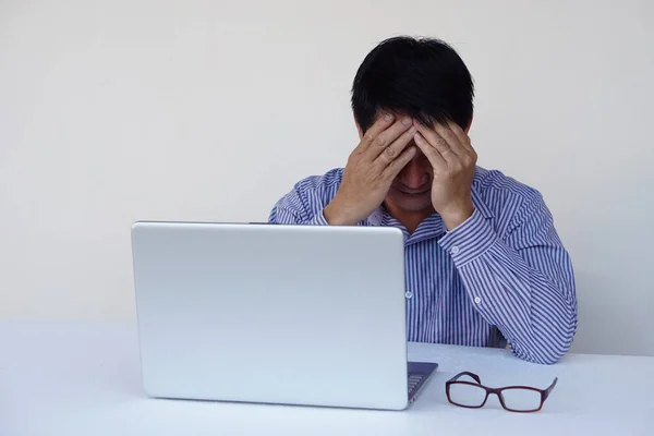 stock image Asian man officer feel depressed during working on computer laptop, covered  face with hands. Concept, hard working, using idea for work, think too much, headache, stressed.                          