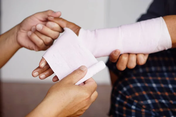 Closeup Man Hands Wrapping Patient Sprained Wrist Elastic Bandage Concept — Stock Photo, Image
