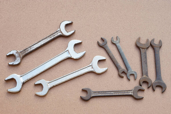 Set of metal wrenches  isolated on brown. Concept, handyman, mechanic tools. Spanners. Equipment for fixing or repairing, renovation in daily life.        