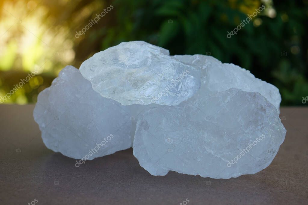 Crystal clear alum stones or Potassium alum on nature background