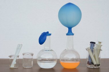 Science experiment , blue inflated balloon  on top of transparent test bottle. The experiment about air or gas reaction by using baking soda and vinegar.Concept,  Science Education                    