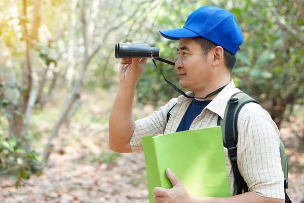Homem Asiático Explorador Usa Boné Azul Mantém Binocular Floresta Para — Fotografia de Stock