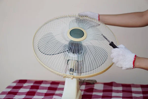 stock image Closeup mechanic hands combine part of electric fan. Concept, maintenace appliance, electric devices in daily life, check ,repair or fix when it has problems for long using.       