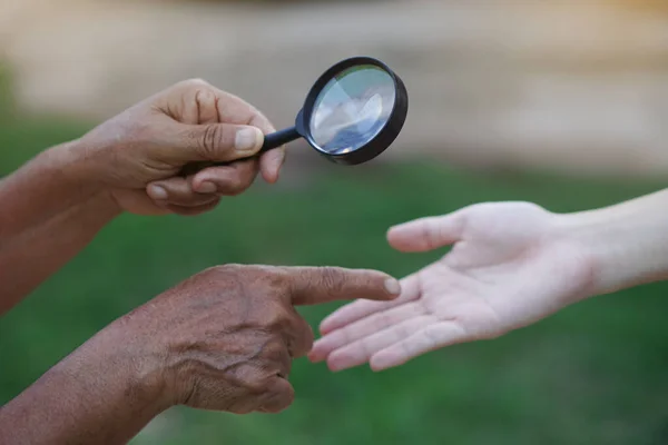 Närbild Hand Håller Förstoringsglas För Att Inspektera Palmer Linjer Begreppet — Stockfoto