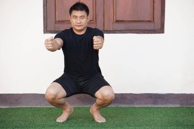 Asyalı adam evde yoga egzersizi yapıyor. Konsept, sağlık hizmeti, fitness, sağlıklı yaşam tarzı. Sağlıklı bir vücutta sağlıklı bir akıl..  
