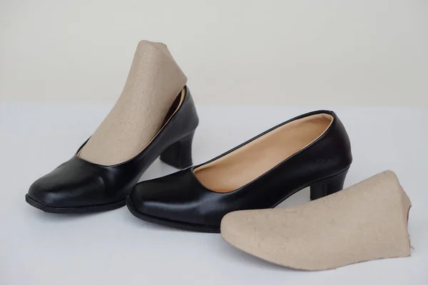 Black high heel shoes for woman,  on white background. Concept, formal and polite footwears for office workers, students or teachers to wear shoes in school or university. Polite uniform.