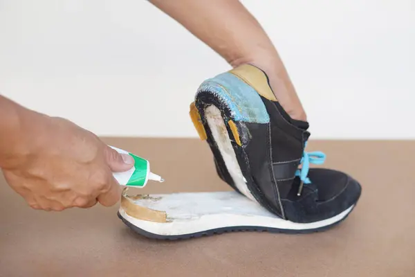 Closeup Man Hand Use Super Glue Fix Broken Shoe Concept — Stock Photo, Image
