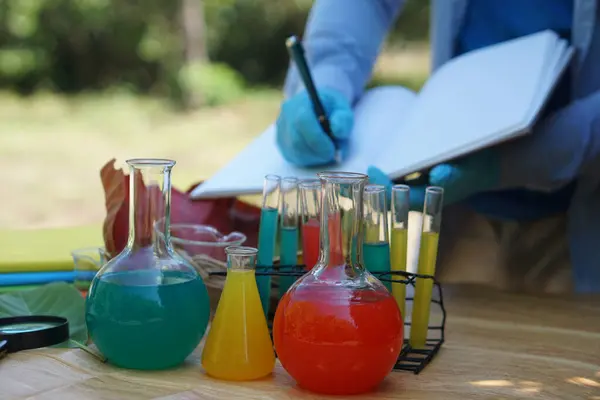 Colorful chemical substance in test tubes for doing science experiment, outdoor. Concept, outdoor teaching and learning. science subject,Project work. Experiment, education, learning by doing approach