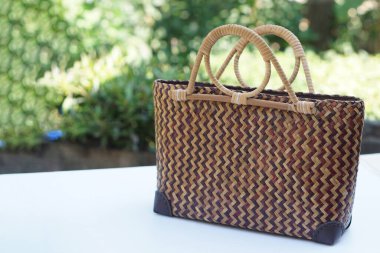 Woven rattan handbag. Handicraft from nature materials. Concept, eco friendly fashion equipment for woman to carry, creative product design by using natural materials to be handbag.      clipart