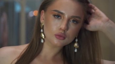 Moda makyajlı, kendine güvenen güzel ve zeki bir kızın portresi. Şehir merkezinin önünde gece poz veren çekici bir model. # Dışarıda duran muhteşem kadın, kapat gözlerini #. 