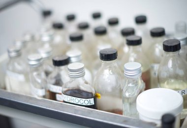 Kumaş ve endüstriyel boyama pamuk labratuvarı fabrikasında kimyasal boya ekipmanları ve beherler. Moda endüstrisi için ölen kumaşlar. Cam şişeler ve şişeler..