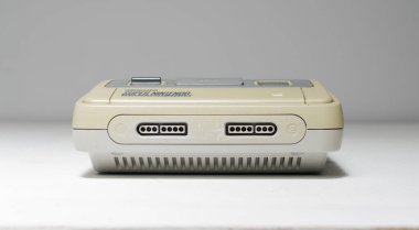 london, uk 03.03.2020 Nintendo snes super nintendo official original video game console,  cartridge slot on a white isolated background. iconic retro super famicon gaming machine.  clipart