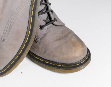 uk, england, 05/05/2022 Dr Martens 1460 grey leather Leather Boots 8 Eye lace hole. fashionable punk historic british made leather boots. dr martens air ware with bouncing soles.  clipart