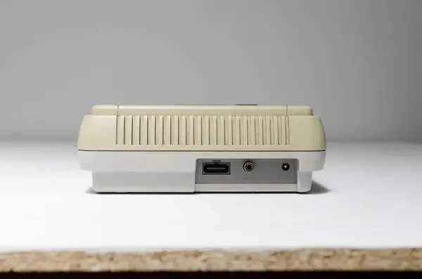 stock image london, uk 03.03.2020 Nintendo snes super nintendo official original video game console,  cartridge slot on a white isolated background. iconic retro super famicon gaming machine. 