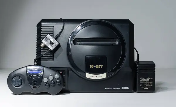 stock image london, uk, 02.03.2021 Sega megadrive 16 bit Console with power adaptor and 3rd party controller.  original retro vintage arcade games console. Retro arcade gaming, computer game history.