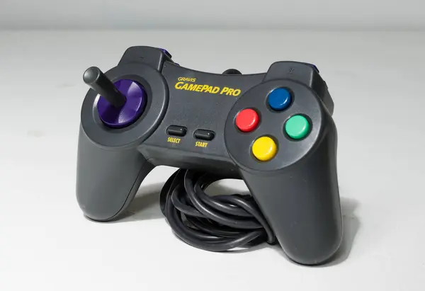 stock image london, uk 05/05/2020 A wired gravis gamepad pro controller on a white studio backdrop. collectable rare home arcade video gaming. joystick and wireless remote technology.