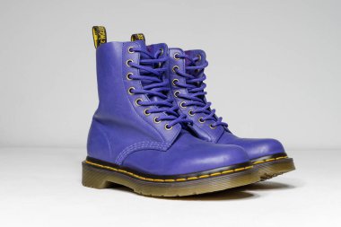 london, england, 05/05/2019 purple and lilac Dr Martens 1460 white Leather Boots 8 Eye lace hole. fashionable punk historic british made leather boots. dr martens air war with bonding soles. built to last.  clipart