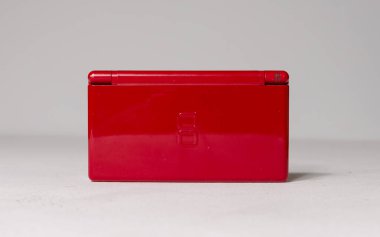 london, uk 05/05/2020A A gloss red nintendo ds lite hand held vintage console bundle, case and games on a white studio background. Retro video gaming handset. nostalgic video gaming clipart